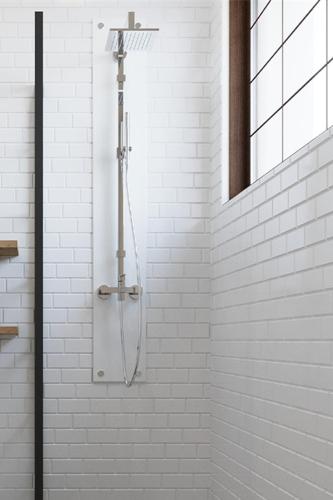 a shower in a bathroom with white tiles at Hotel Sunpark Inn in Chennai