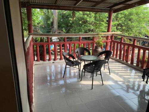 a patio with a table and chairs on a porch at Homestay Pokdin in Kuantan