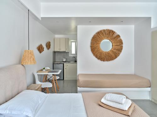 a bedroom with a bed and a mirror on the wall at Corina Studios-Apartments in Naousa