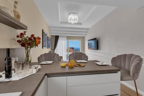 a kitchen with a table with a vase of flowers at Apartment Vranješ in Makarska