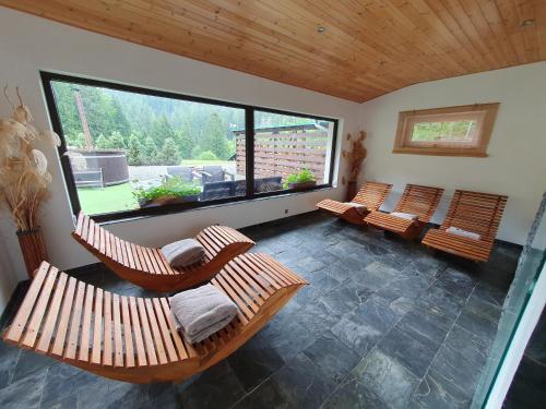 a living room with three chairs and a large window at Ski park Gruň in Staré Hamry