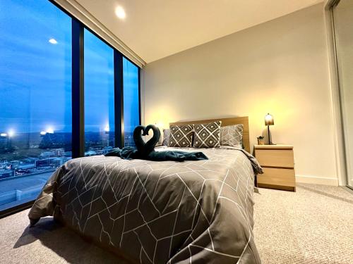 a bedroom with a large bed with a swan on it at "The Oak" in the heart of CBD in Adelaide