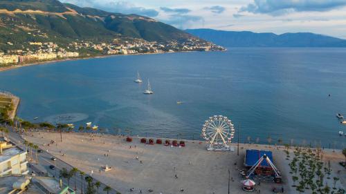a beach with a ferris wheel in the water at Dot Tradition in Vlorë