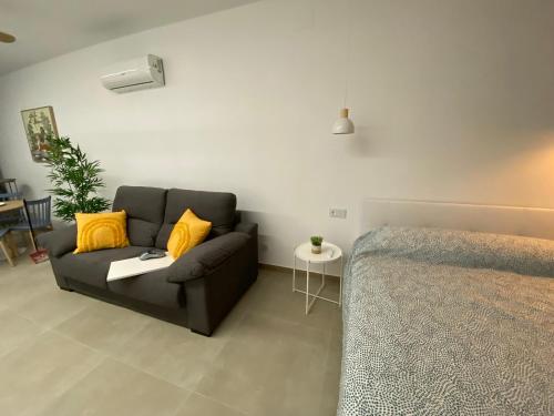 a living room with a couch and a bed at Santa Pola Suites in Santa Pola