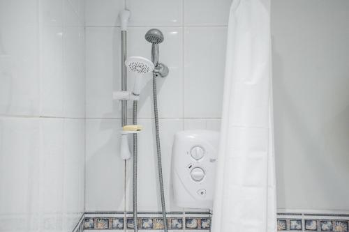 a shower in a bathroom with a shower curtain at A delightful flat in Manchester. in Manchester