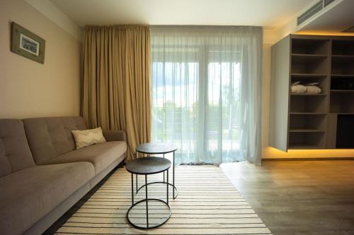 a living room with a couch and a table at Wellness Hotel Volarik in Mikulov