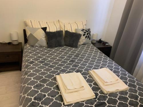 a bedroom with a bed with two towels on it at Centrum Apartment Lipowa 12 in Białystok
