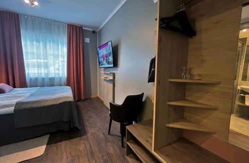 a hotel room with a bed and a sliding glass door at Hotell Funäsdalen in Funäsdalen