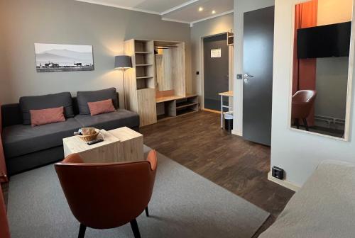 a living room with a couch and a table at Hotell Funäsdalen in Funäsdalen