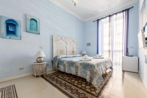 a bedroom with a bed and a large window at [Double Suite] - Prestige and Deluxe in Naples