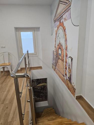 a staircase with a painting on the wall at Apartamentos Plaza Santo Domingo in Cádiz