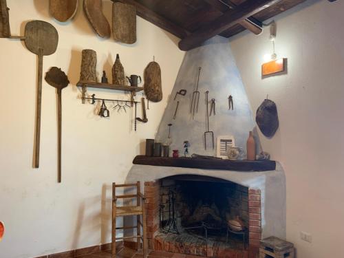 a living room with a fireplace and artifacts on the wall at Tentadore in La Caletta