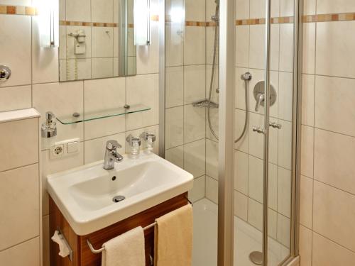 a bathroom with a sink and a shower at Appartement-Haus Blumenhof in Bad Griesbach
