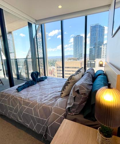 a large bed in a room with a large window at "The Oak" in the heart of CBD in Adelaide