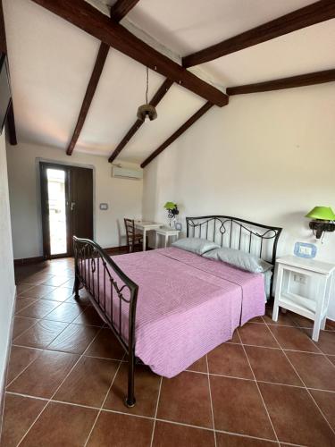 a bedroom with a large bed in a room at Tentadore in La Caletta