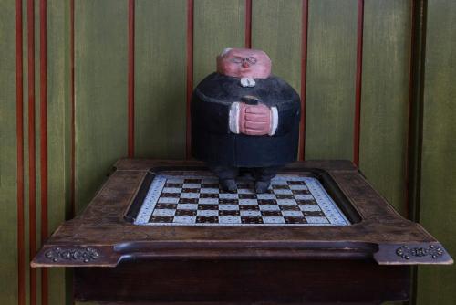 a statue of a man on a chessboard on a table at Villa Wäring Husrum & Frukost in Varberg