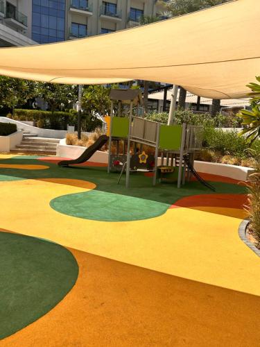 a carpeted area with a playground with a slide at The Address Residence Fujairah in Fujairah