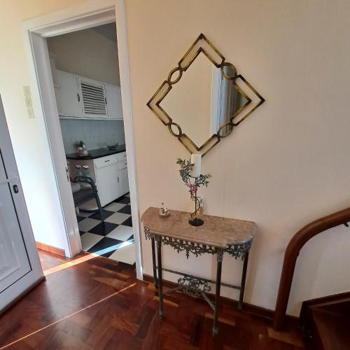 a room with a table and a mirror on the wall at Chalé Funchal - City view in Funchal