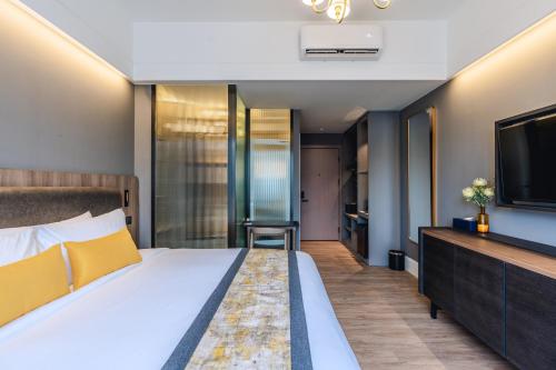 a hotel room with a bed and a tv at Bandalo Boutique Hotel - Patong Beach Road in Patong Beach