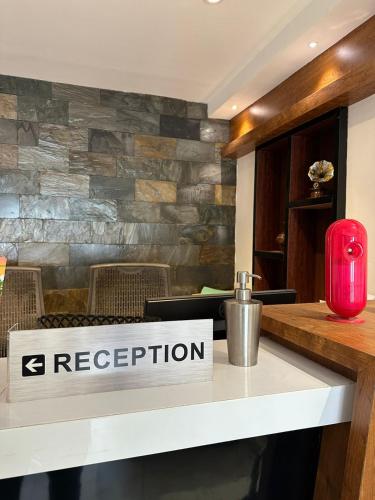 a restaurant counter with a sign that reads reception at Hotel Vrindavan in Wayanad