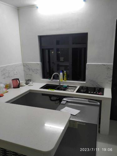 a white kitchen with a sink and a stove at A 7 Villa in Quartier Militaire