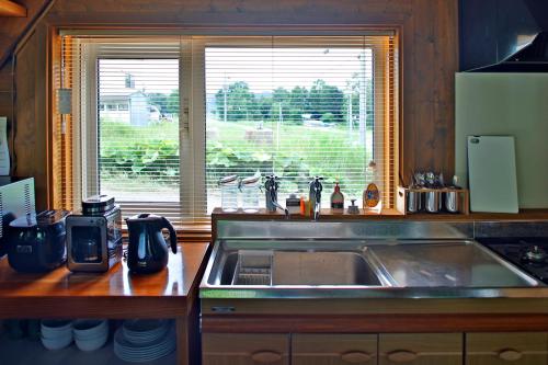 a kitchen with a sink and a window at The LODGE ABASHIRI in Abashiri