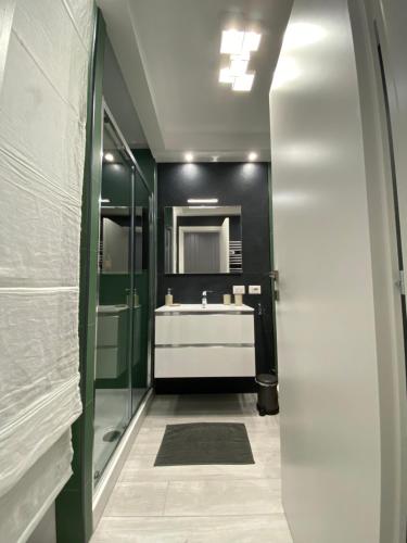 a bathroom with a sink and a mirror at Loft Torlonia in Rome