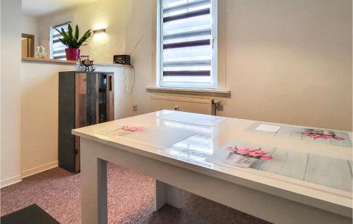 a table in a room with pink flowers on it at 2 Bedroom Nice Apartment In Friedrichroda in Friedrichroda