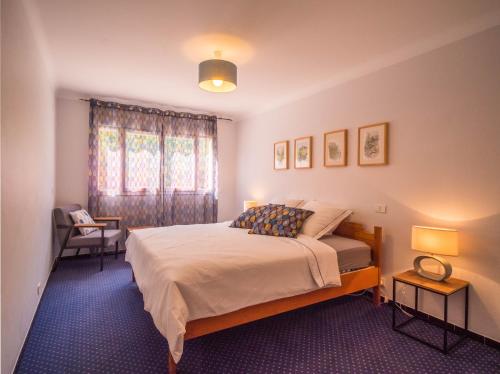 a bedroom with a bed and two lamps and a window at Camping Hotel Les Rives du Loup in Tourrettes-sur-Loup