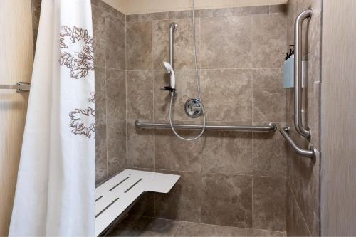 a bathroom with a shower with a shower curtain at Residence Inn by Marriott Fredericksburg in Fredericksburg