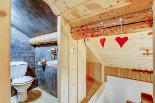 a wooden bathroom with a toilet and a sink at Chalet Arthur in Morzine
