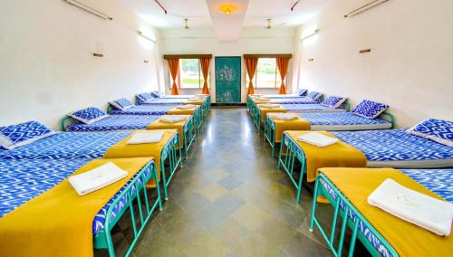 a row of beds in a room at Ramoji Sahara Shared Accommodation in Pedda Ambarpet