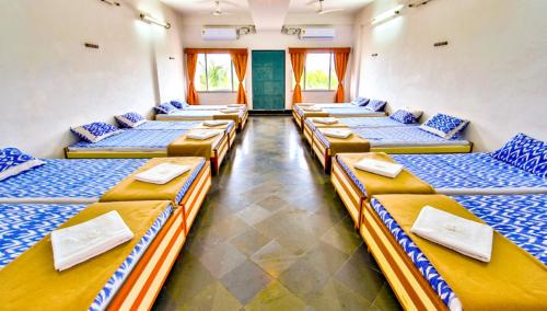 a room with a bunch of beds in it at Ramoji Sahara Shared Accommodation in Pedda Ambarpet