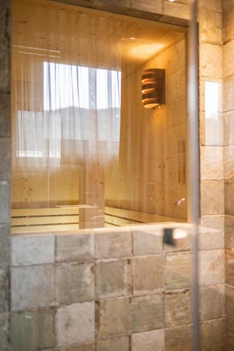 a reflection of a room with a window at Loewe Dolomites in San Candido