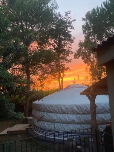 a large white barrel with a sunset in the background at Yurta Arco Iris in Riba-Roja De Turia