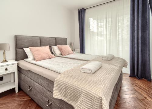a bedroom with two beds with towels on them at Apartament Porto - ACCO RENT in Gdynia