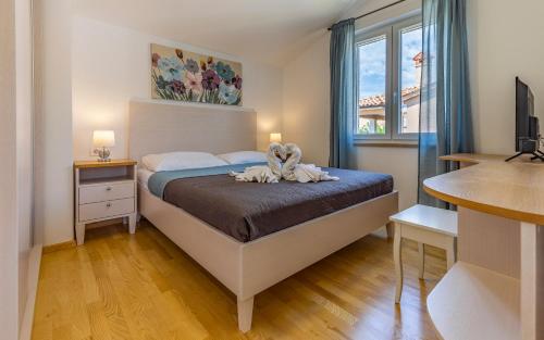 a bedroom with a bed with a flower on it at Lotus Villas Resort in Pula