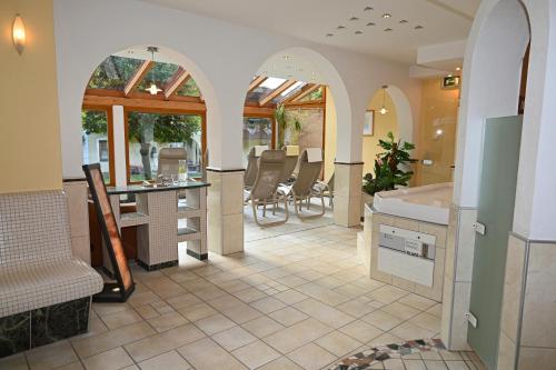 a bathroom with a tub and a sink in a room at Ferienparadies Truppe in Velden am Wörthersee