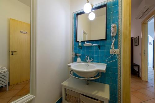 a bathroom with a sink and a mirror at Solaria in Amalfi