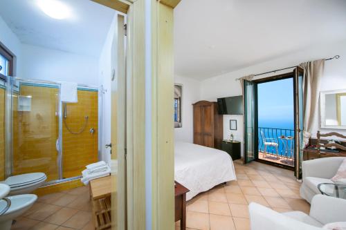 a hotel room with a bed and a balcony at Solaria in Amalfi