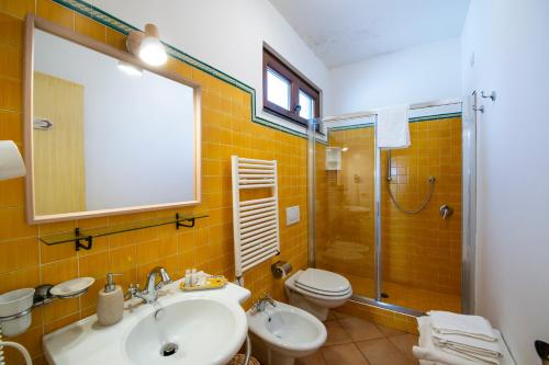 a bathroom with a sink and a toilet and a shower at Solaria in Amalfi