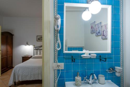 a bathroom with a shower and a sink and a bed at Solaria in Amalfi