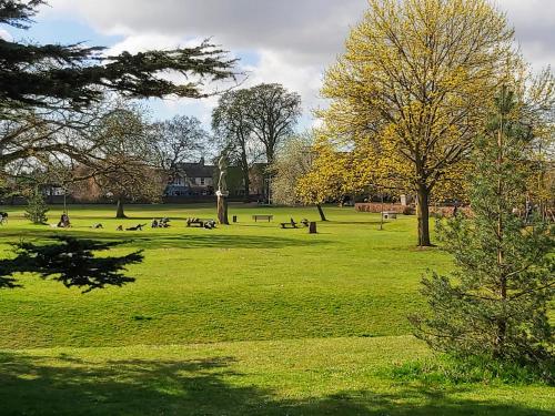 a park with people sitting in the grass at Oxford Guest House in Oxford