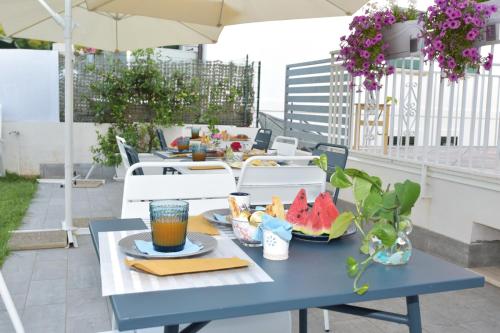 a blue table with food and drinks on a balcony at Luna Calante in Santa Maria di Castellabate