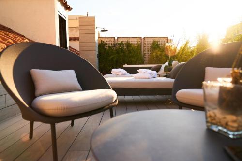 a row of chairs sitting on top of a patio at Hotel Regina in Madrid