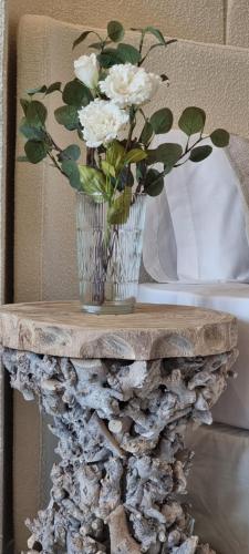 a vase with white flowers on a rock table at MD Pare Presentat in Valencia