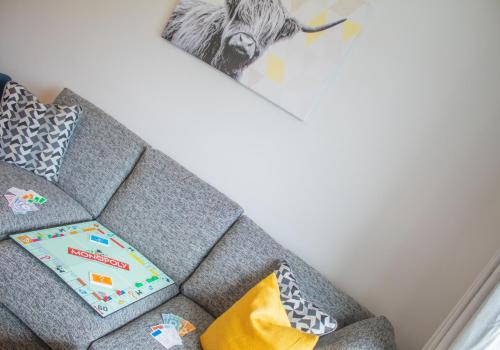 a book sitting on a couch in a living room at 10 Bynack House in Aviemore