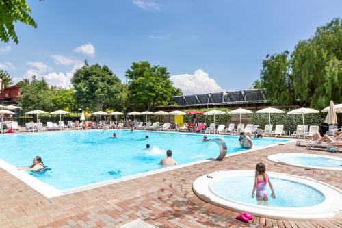 a group of people swimming in a swimming pool at hu Roma Camping In Town in Rome