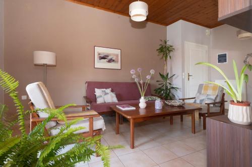 a living room with a couch and a table at Studio Dionphaie - Διόνφαιη in Pylos