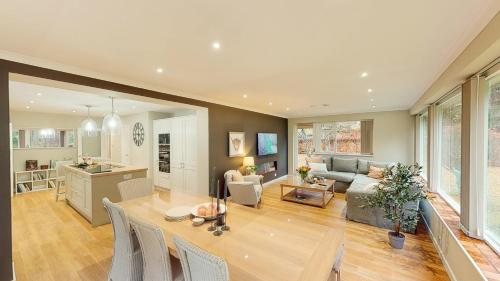 a kitchen and living room with a table and chairs at Dalnaglar in Nethy Bridge